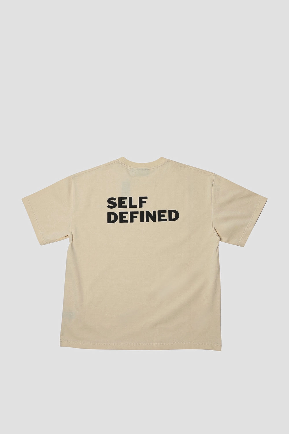 Back of the seedpearl DROP 001 tee with SELF DEFINED in raised puff print