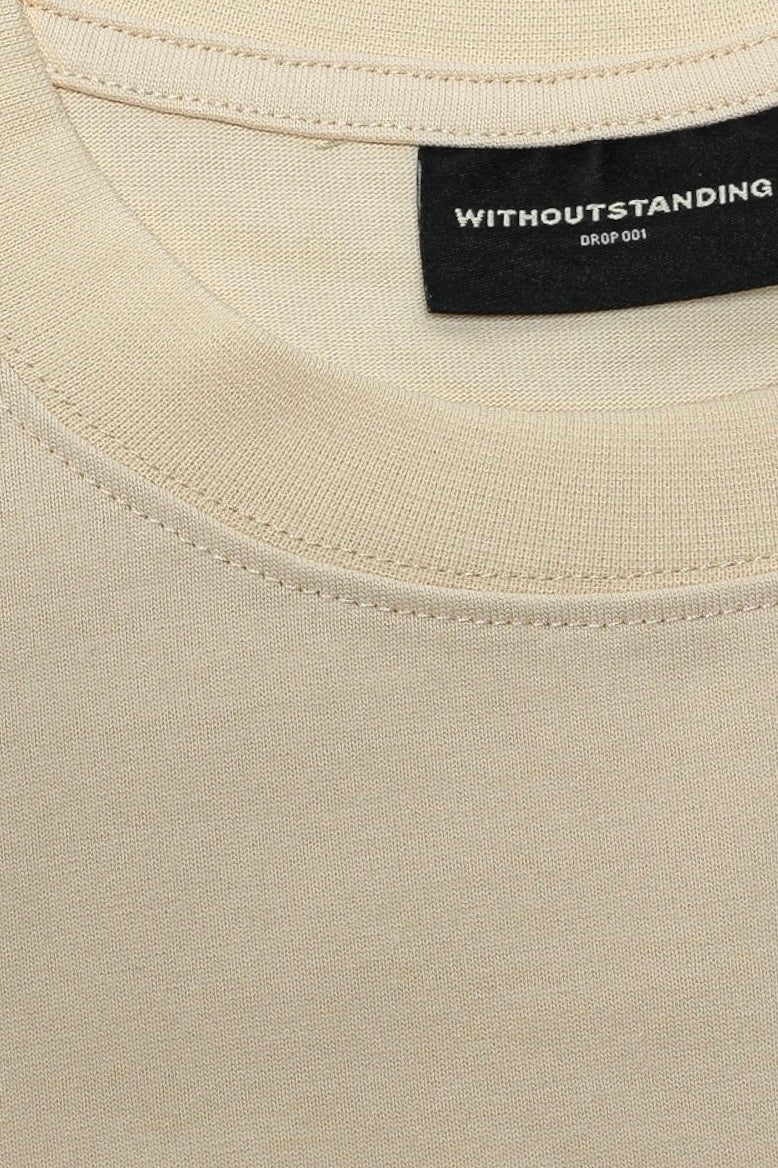 Close-up of the rib crew neckline and WITHOUTSTANDING neck label