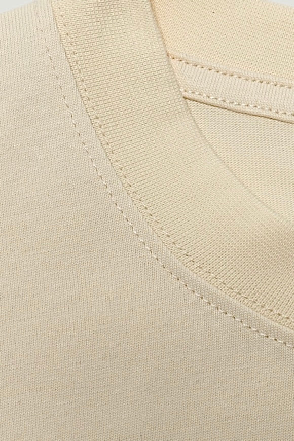 Close-up of the tight rib crew neckline on the seedpearl DROP 001 tee