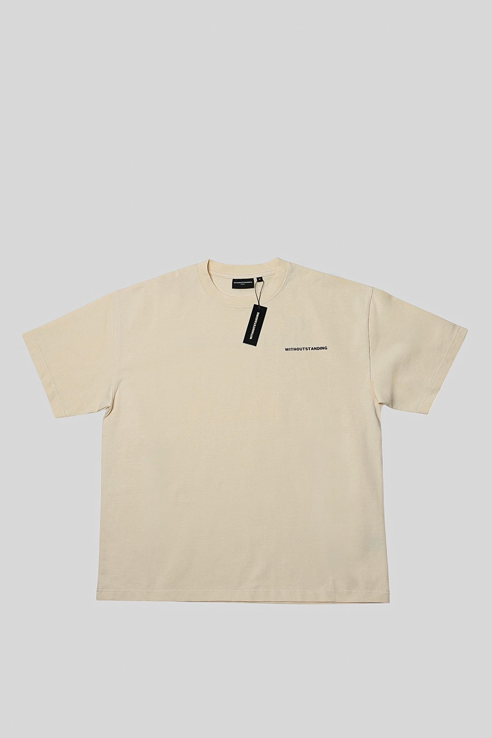 Front of the seedpearl DROP 001 tee with black WITHOUTSTANDING hang tag
