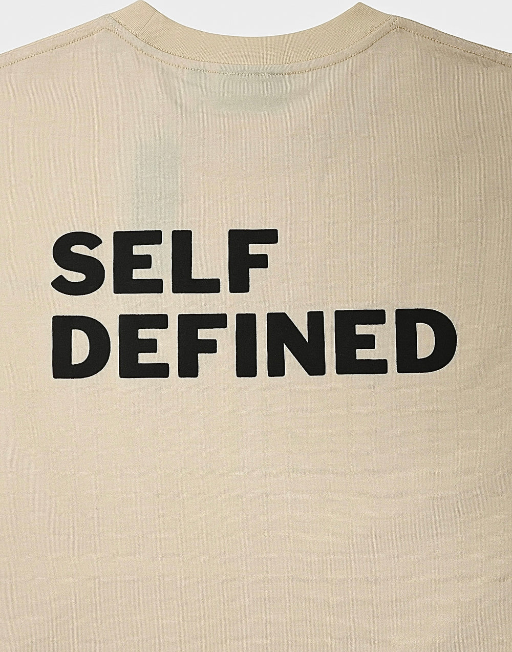 Upper back of the seedpearl DROP 001 tee with a large SELF DEFINED raised print