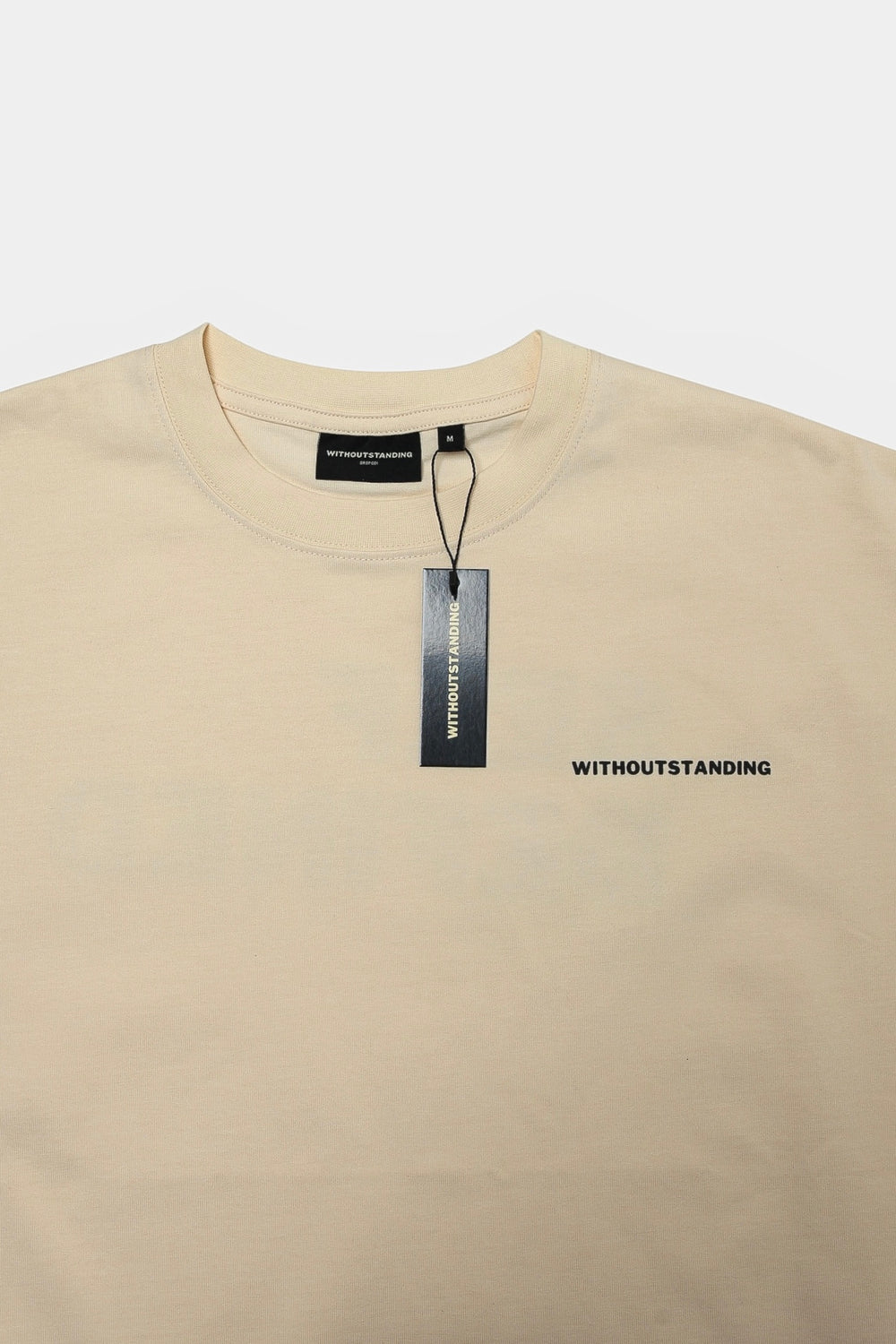 Front of the seedpearl DROP 001 tee with the WITHOUTSTANDING chest print