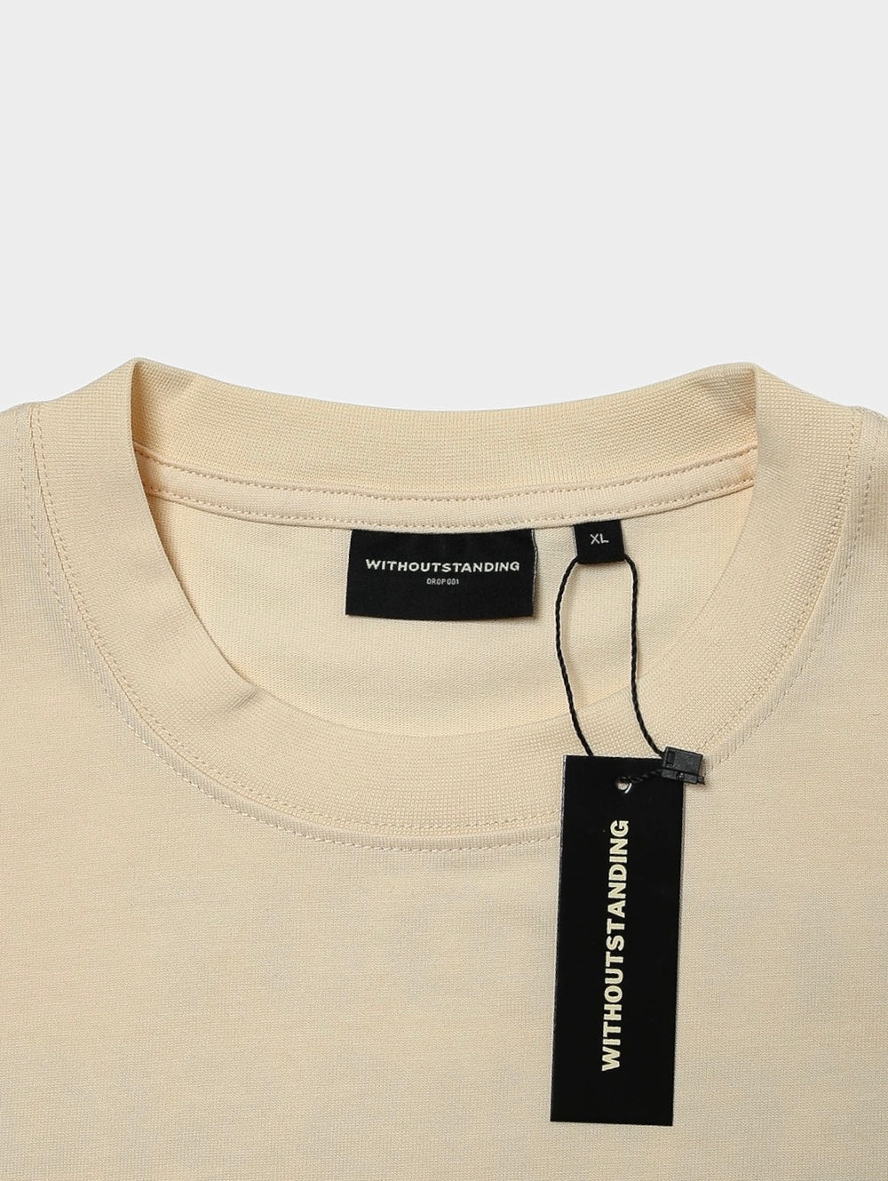 Rib crew neckline of the seedpearl DROP 001 tee with black hang tag
