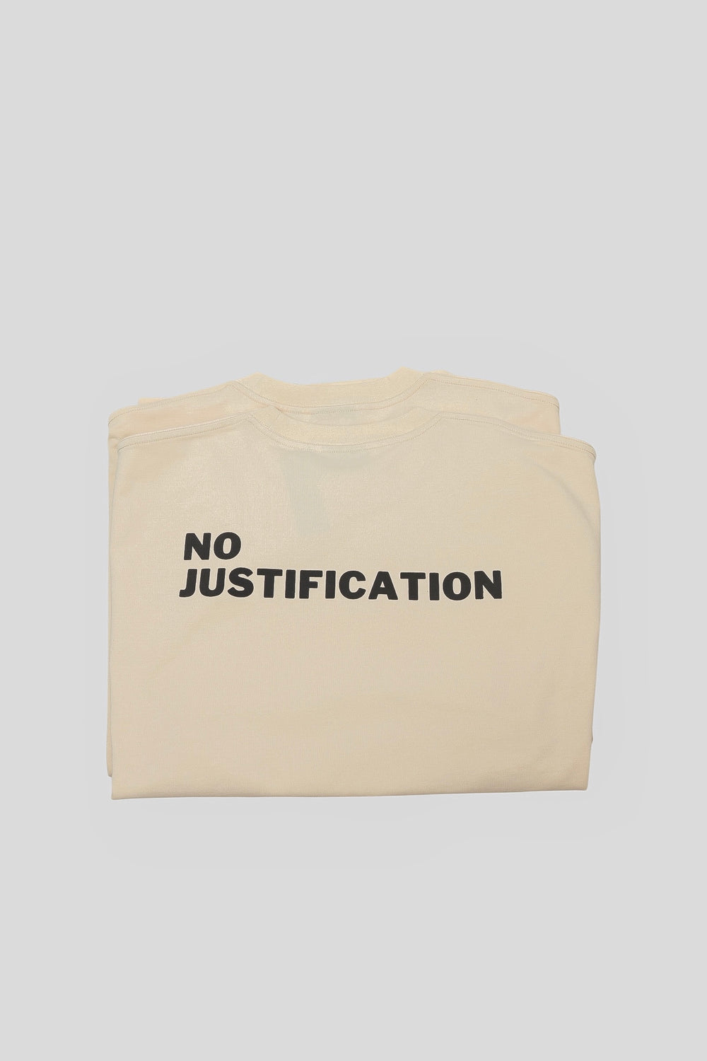 Folded seedpearl DROP 001 tee with the NO JUSTIFICATION print visible