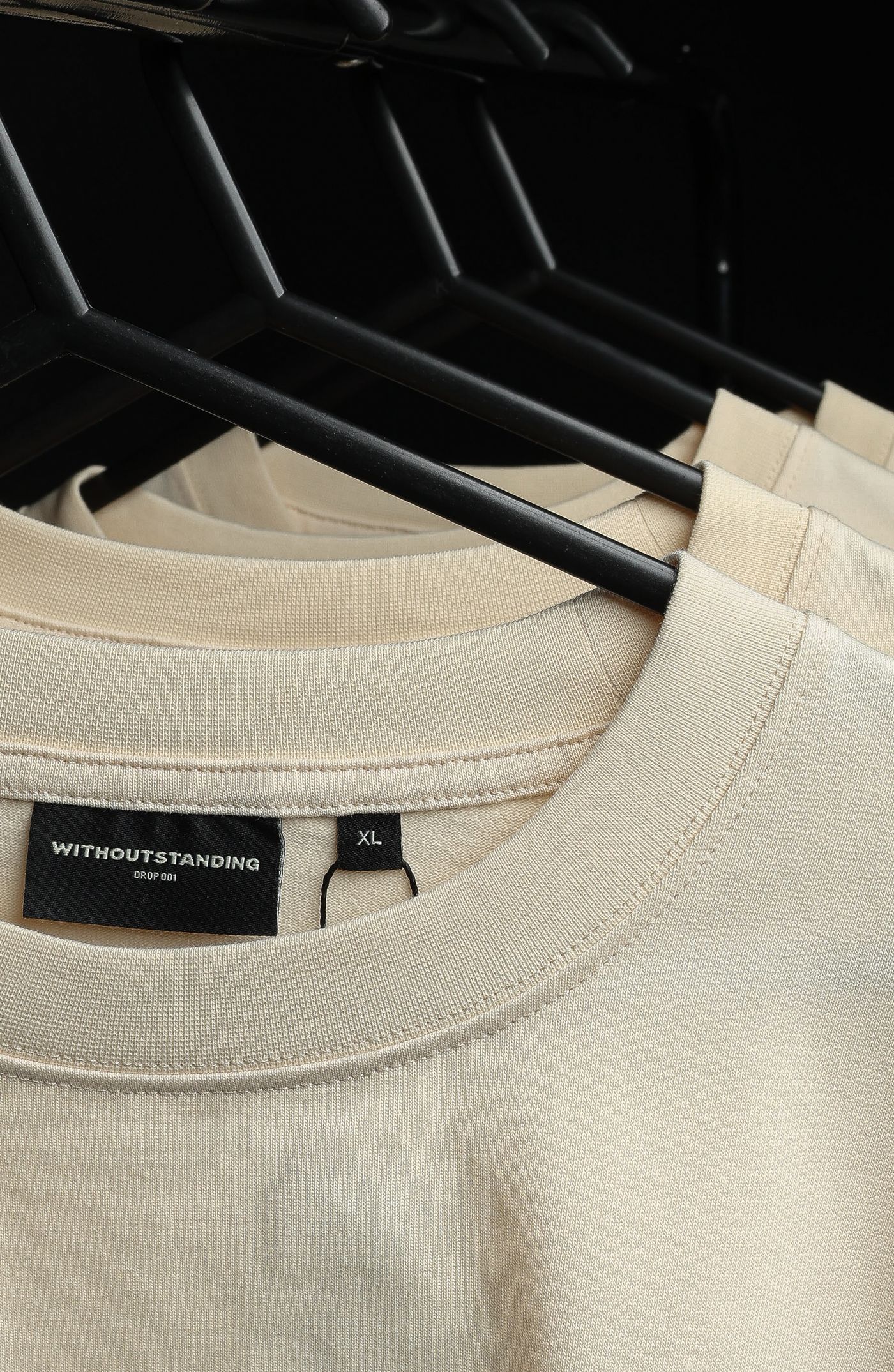 Close-up of the tight rib crew neckline in seedpearl cotton