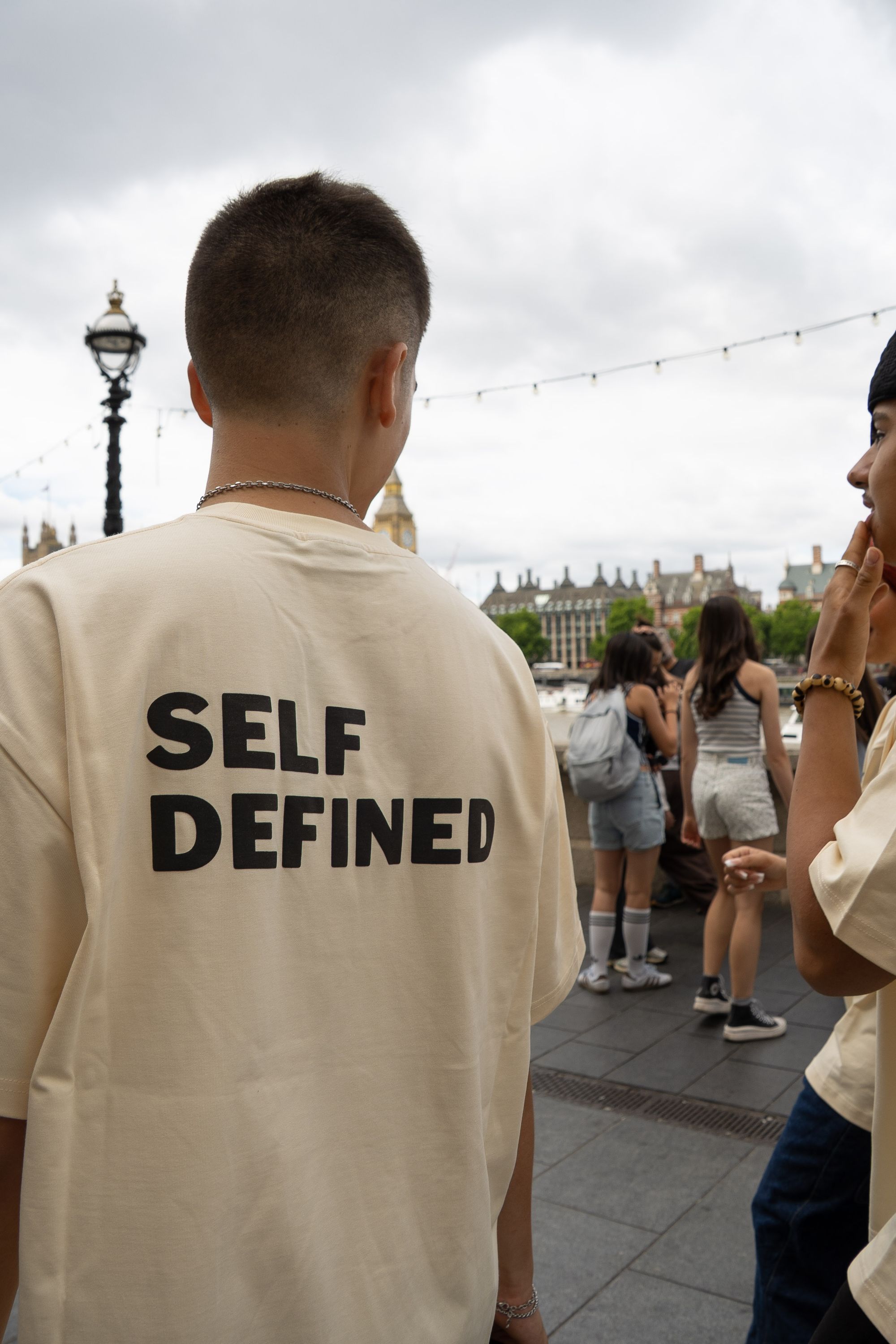 SELF DEFINED worn by the river in London, seen from behind